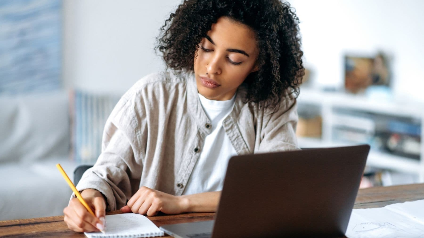 Woman writing on notepad